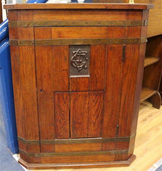 An oak Arts and Crafts corner cupboard W.74cm